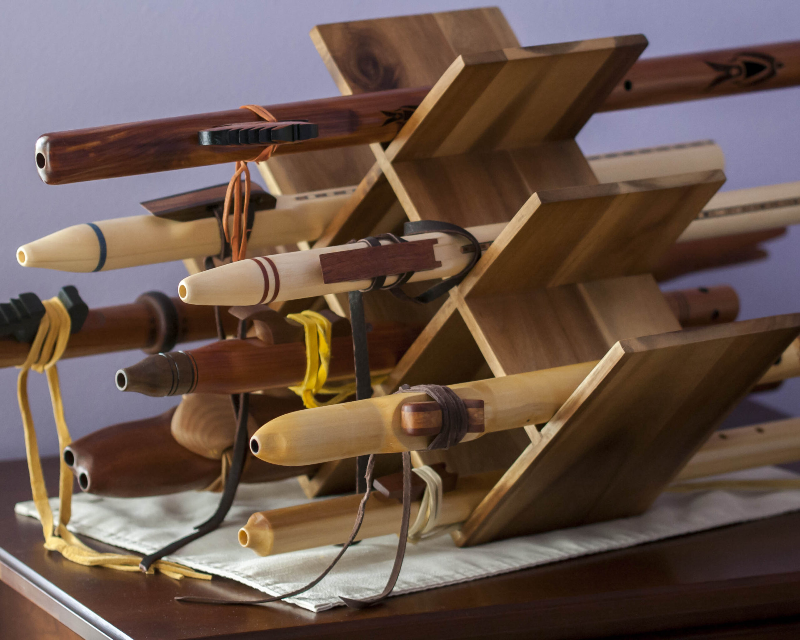 wooden flutes displayed on a wine rack