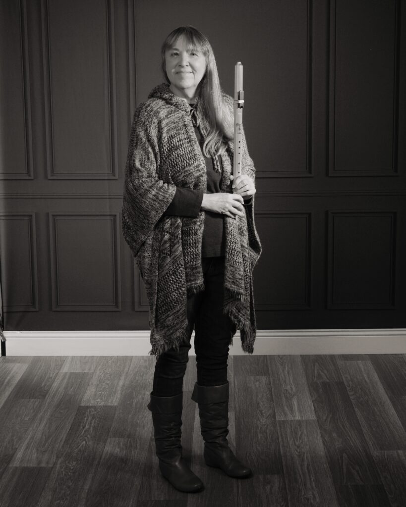 black and white photo of Diane Wheeler Dunn standing holding a flute