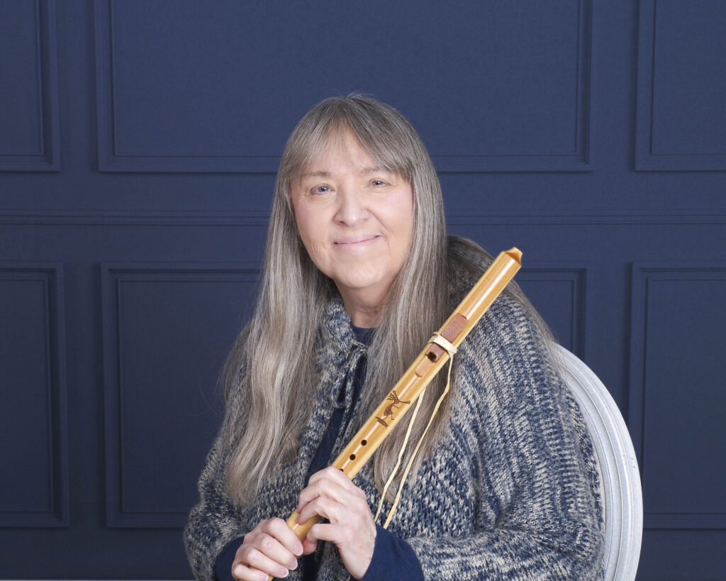 photo of Diane Wheeler Dunn sitting holding a flute